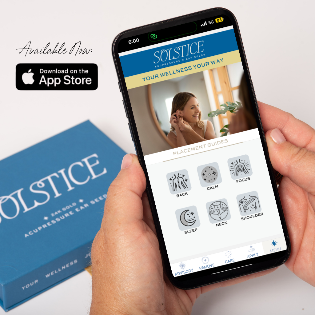 Person holding Solstice Ear Seed Placement app on apple iphone, available at the app store.